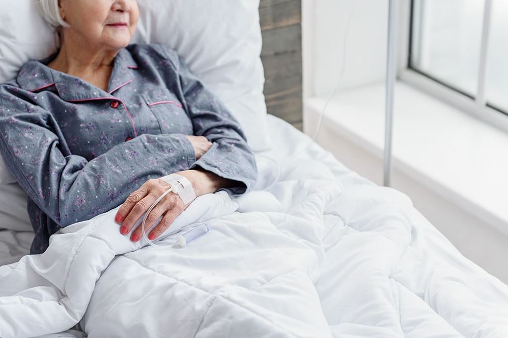 Woman Sitting in Hospital Bed