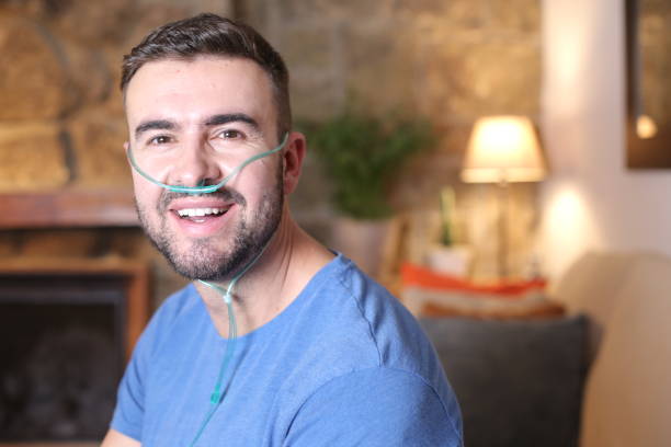 Man in living room wearing oxygen tubing