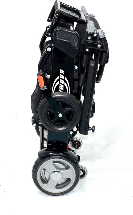 A Karman Tranzit Go wheelchair is folded compactly and standing upright on its own