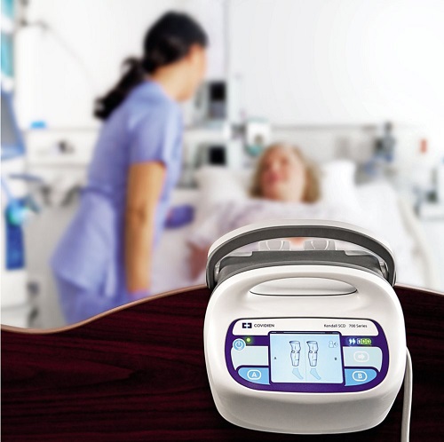 The Kendall SCD 700 Homecare Pump on a hospital bed footboard.