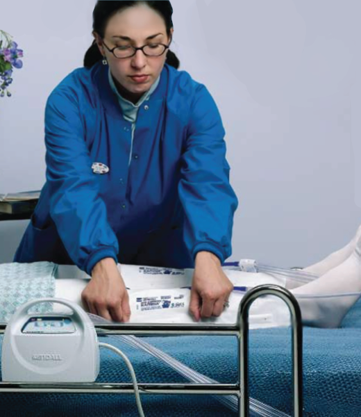 A healthcare worker secures the SCD Express Sleeve on a patient's leg