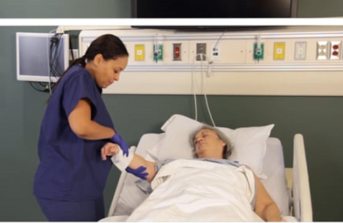 data-element= Hospital Caregiver Washing Patient's Arm With ReadyBath Cloths