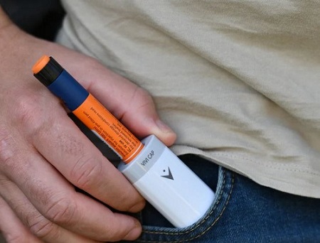 data-element= The device in the pocket of a pair of jeans.