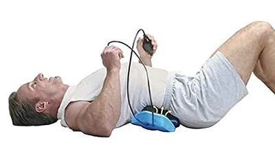 A man using the Porsture Pump Elliptical Back Rocker 2000 to stretch his lower back.