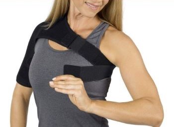 data-element= A woman adjusts the brace for the best fit